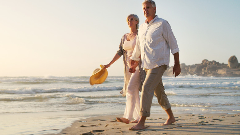 Mature couple walking along the beach