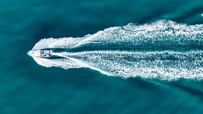 overhead shot of a boat moving across the water