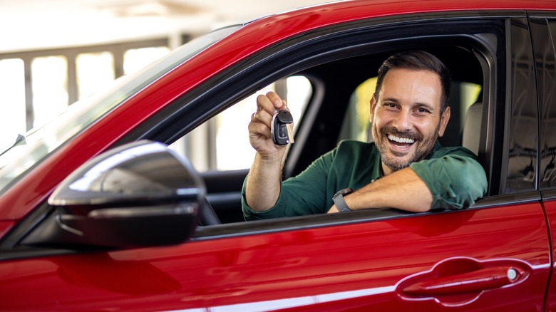 man in a brand new car