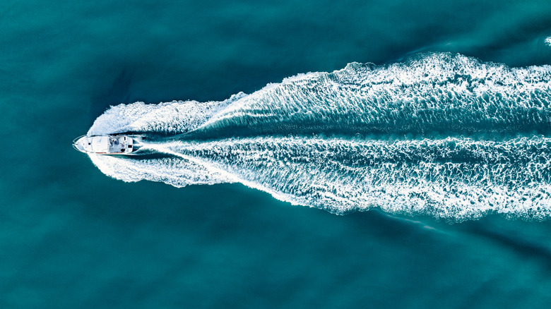 overhead shot of a boat moving across the water