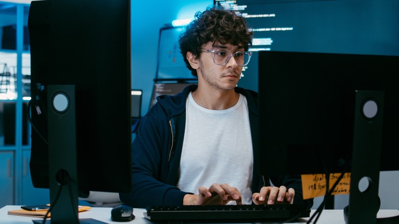 man typing at a computer