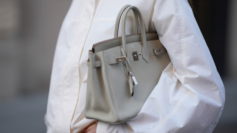 Woman holds Hermes Birkin bag
