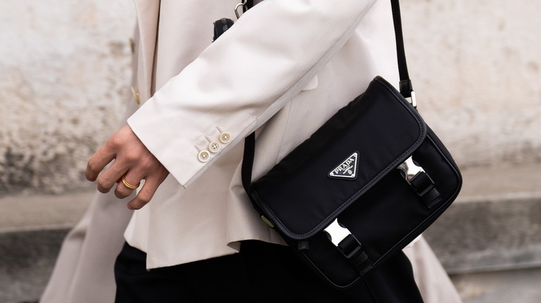 Woman walking with Prada Re-Nylon bag