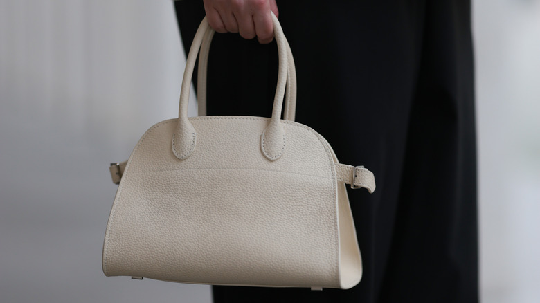 Woman holding  Row Margaux bag