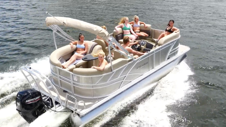 A group of people riding on a Sylvan Mirage 820 LZ
