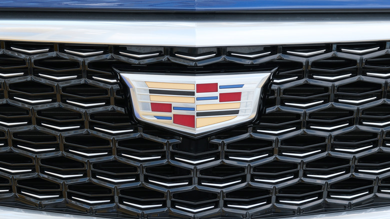 A close-up of the Cadillac logo on a vehicle's grill.