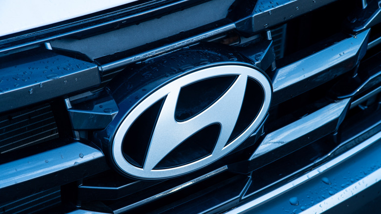 A close-up of the Hyundai logo on the grill of a car.