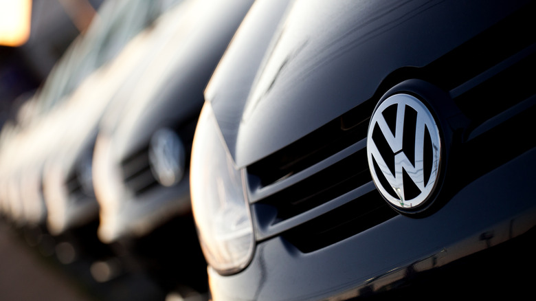 A close-up view of a row of new Volkswagens.