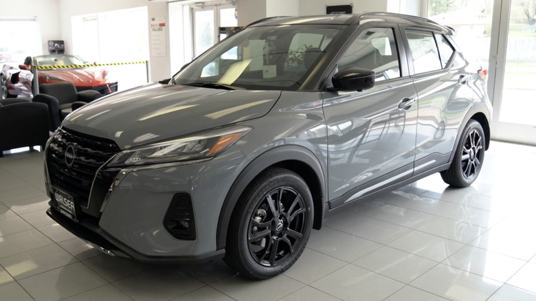 A gray 2022 Nissan Kicks on display at a dealership