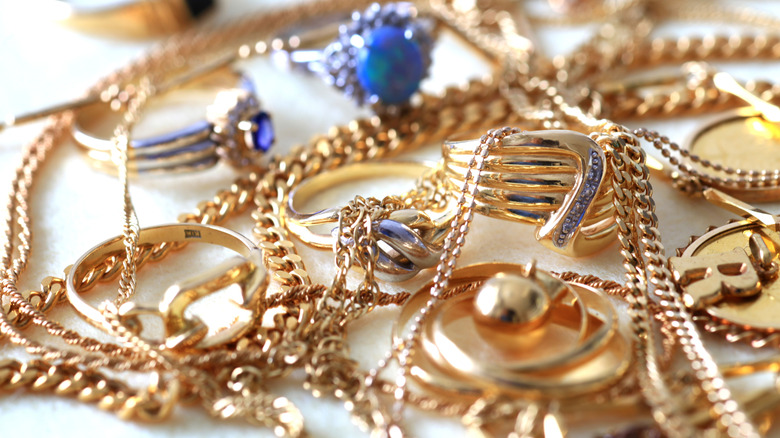 A pile of various gold necklaces and other types of jewelry