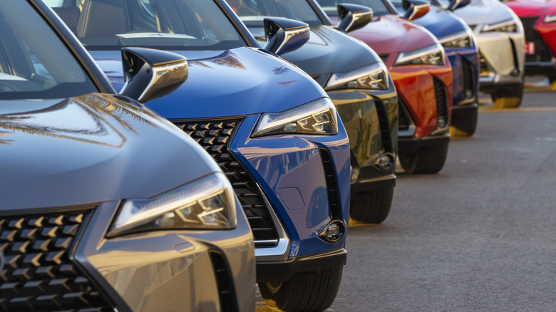 Lexus UX (Toyota Group) SUV vehicles in hybrid version parked on public parking before the drives.