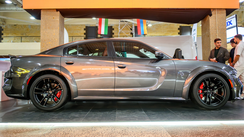 Gray sports dodge charger on display at auto show.