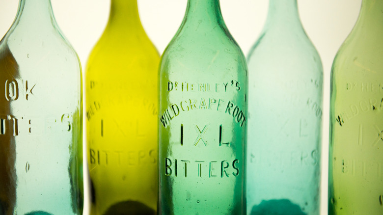 Close up of green antique bitter bottles.