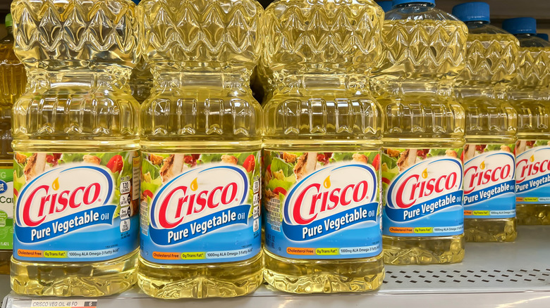 Bottles of Crisco oil on a grocery store shelf