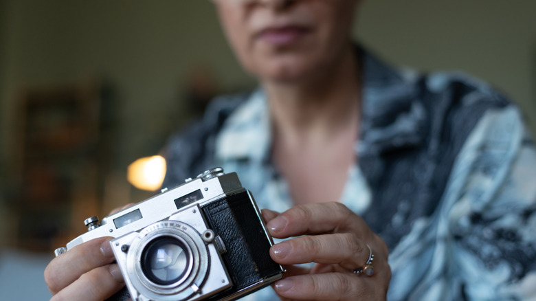 woman holding a vintage camera