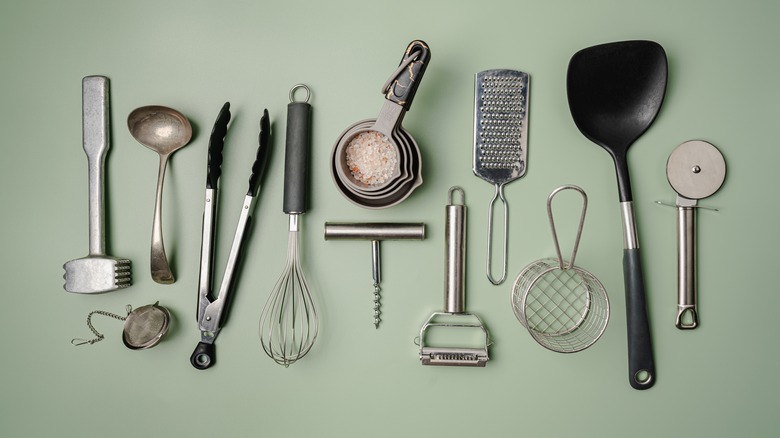 Various kitchen utensils laid out in rows