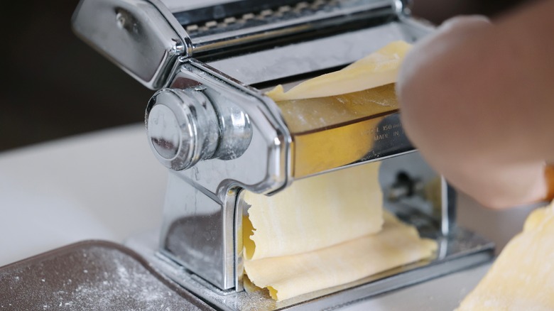 a standalone roller being used to create fresh pasta