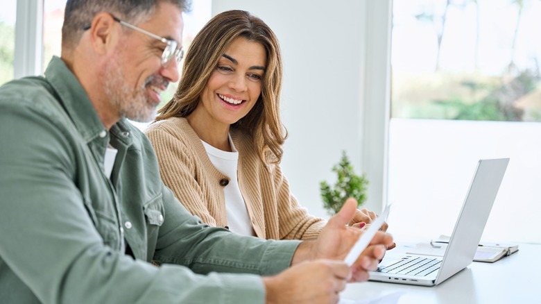 middle aged savers looking at retirement documents