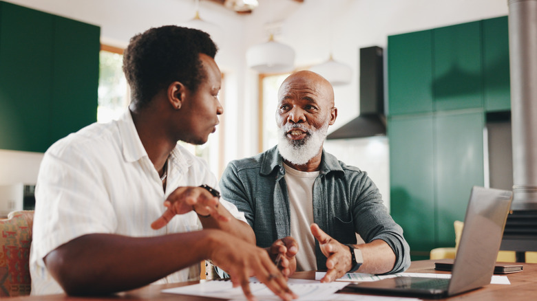 father and son discussing finances