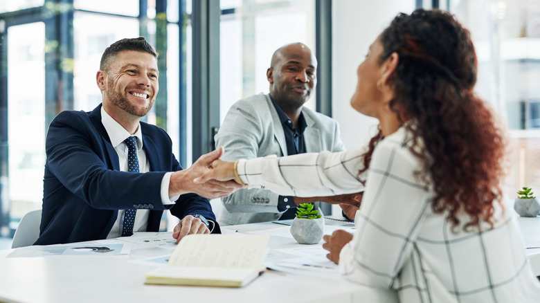business people shaking hands in office