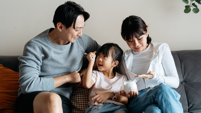 a family sitting on couch with child