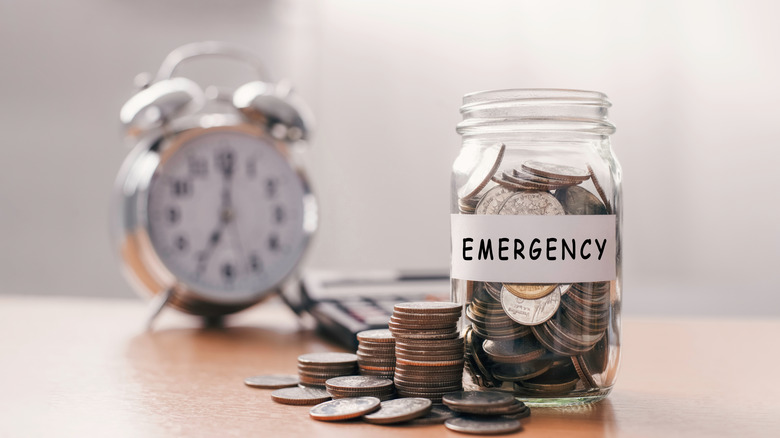 coins in a jar labeled emergency