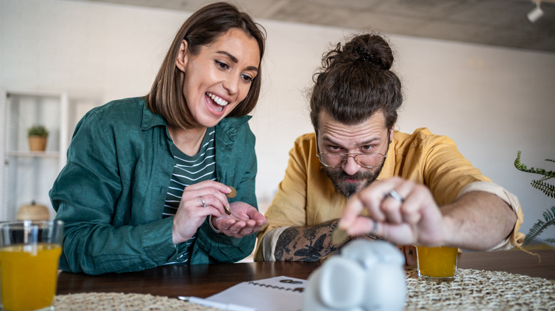 young couple saving money together