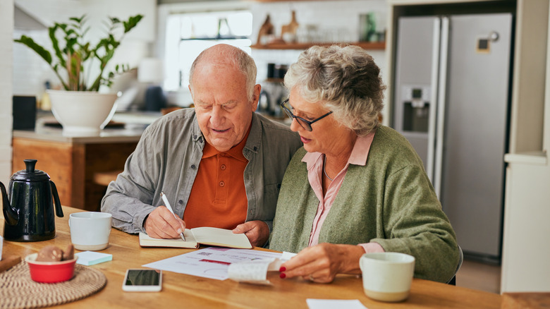 senior couple calculating budget needs