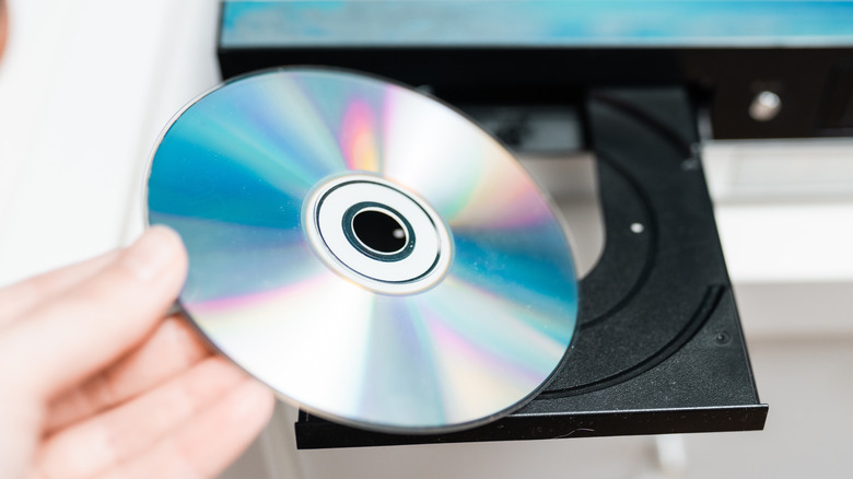 Close up of DVD as it's getting placed into a DVD player