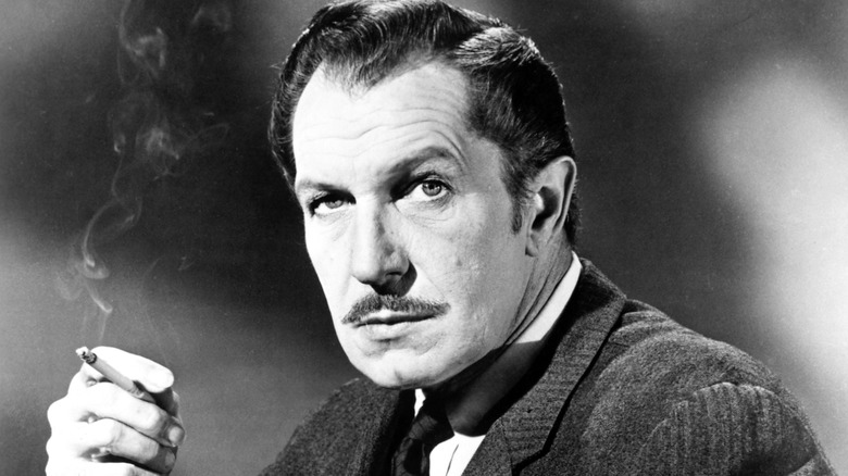 Black and white image of actor Vincent Price holding a cigar
