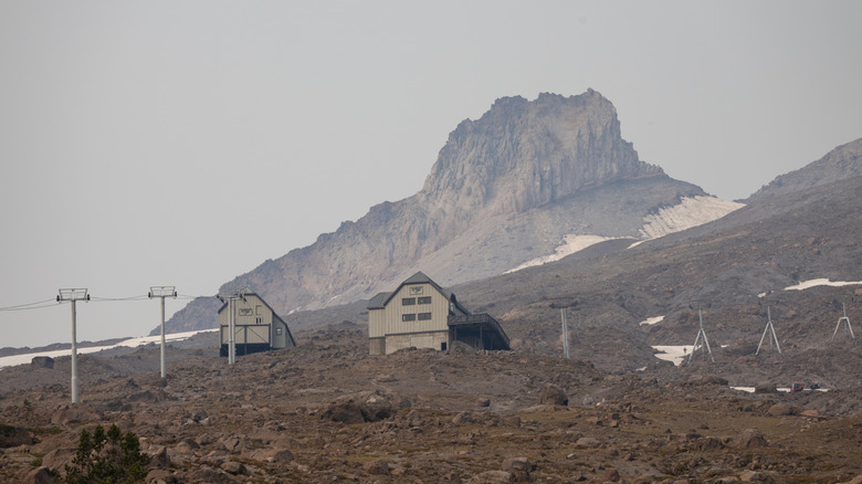 Snow on the peak of Mount Hood in northern Oregon on a late summer day with wildfire smoke in the sky.