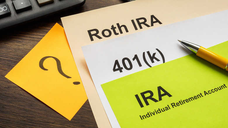 Documents with Retirement plans IRA, 401k and Roth IRA for choosing.