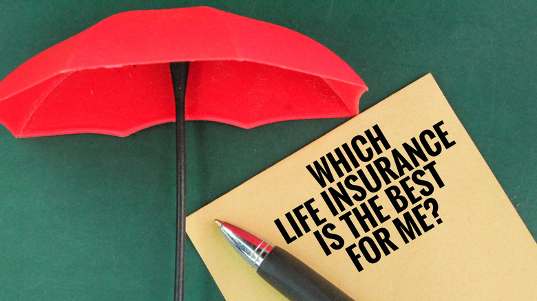 An umbrella, a pen and a book with the question word WHICH LIFE INSURANCE IS THE BEST FOR ME?