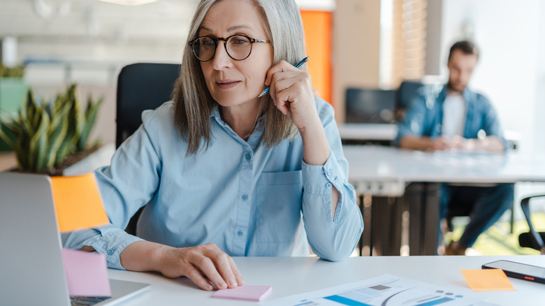A senior citizen worker at a desk