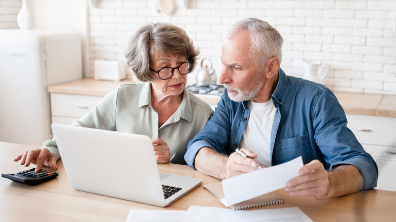 Confused looking older couple at a computer