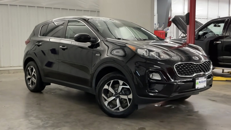 A black 2022 Kia Sportage parked in a garage