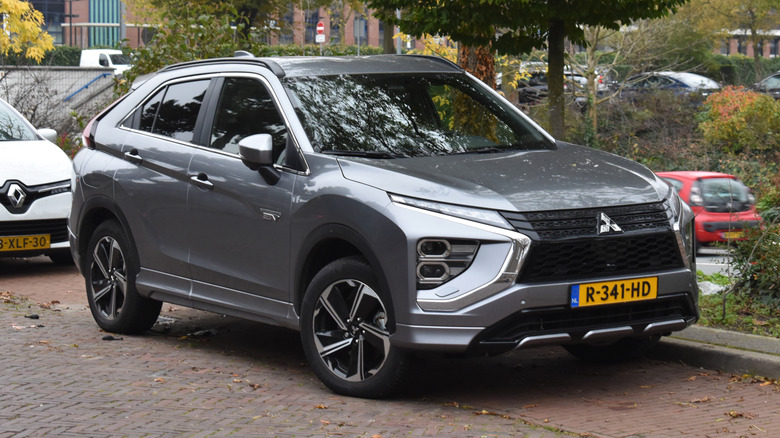 A gray 2022 Mitsubishi Eclipse Cross parallel parked on a brick road