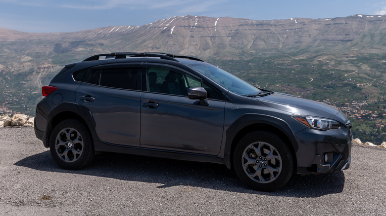 Subaru Crosstrek Sport on the road with mountains in the background