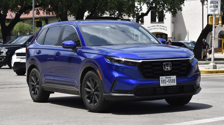 A blue Honda CR-V driving on the street.