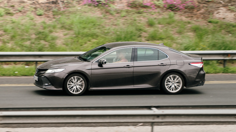 A Toyota Camry on a highway.