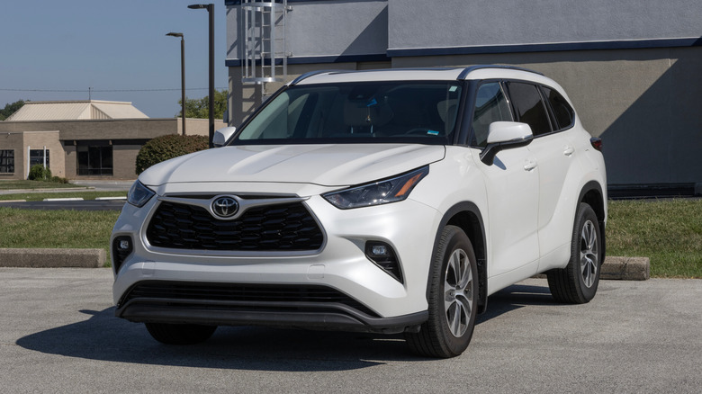 A white Toyota Highlander parked in a parking space.