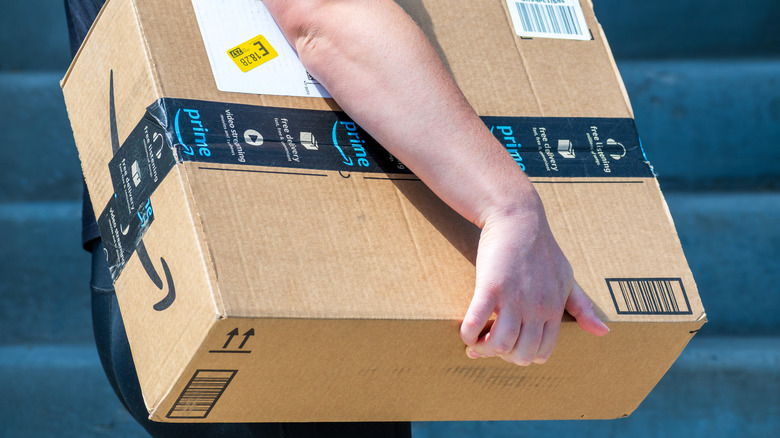an Amazon delivery driver carrying boxes