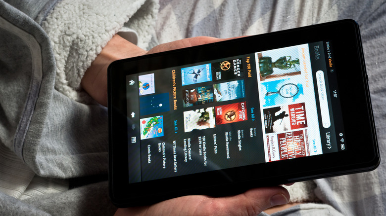 person holding an Amazon Kindle device