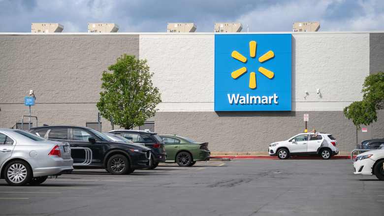 Close up of outside of Walmart supercenter with cars in parking lot
