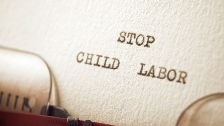 A close up of paper in typewriter with words "stop child labor" on it