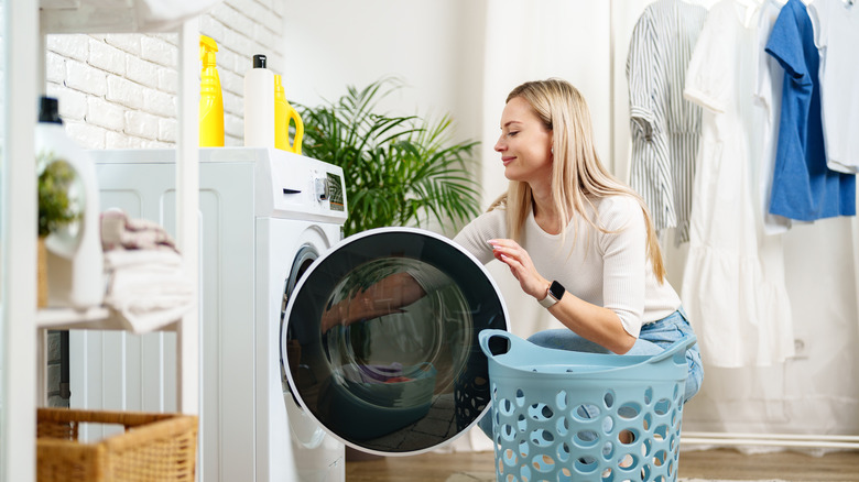 woman taking laundry out of a washing machine