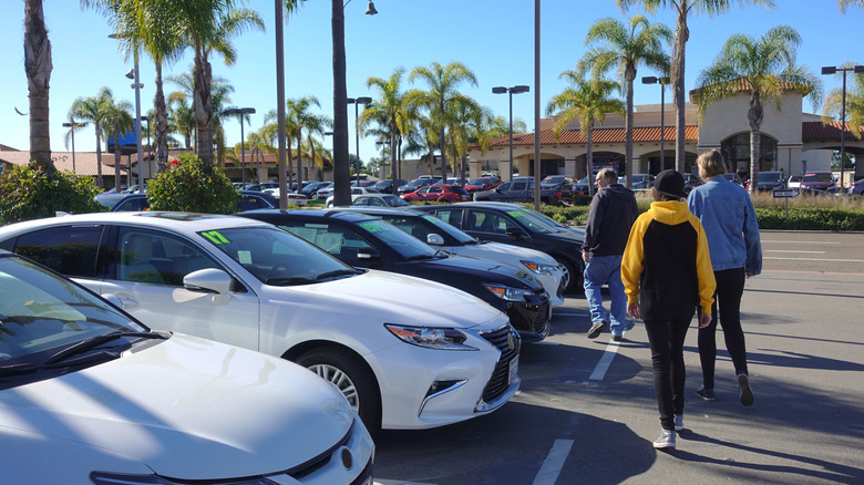 parent and teen shopping for a used car