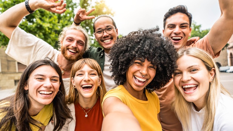 group of millennials taking selfie