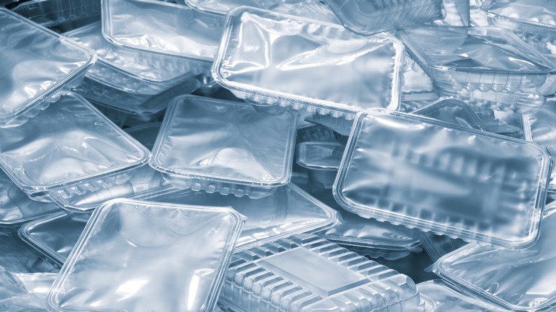 A pile of rectangular plastic food containers