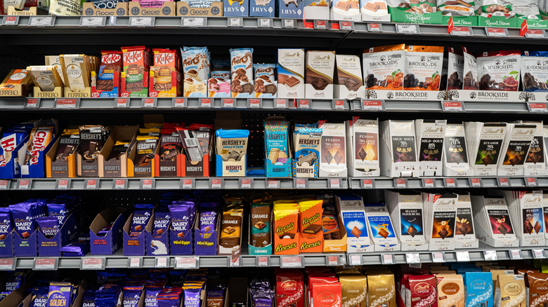 Grocery store shelves filled with name brand chocolate candies